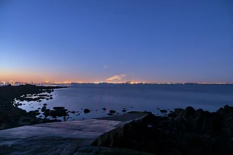Sunset at Seapoint Beach. Wide angle view of ppower stations in Dublin Stock Photos