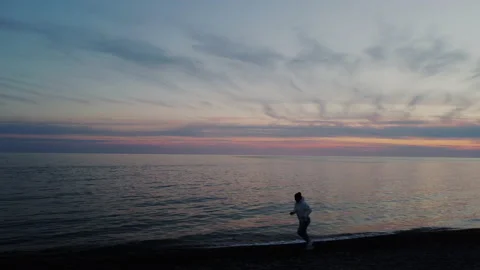 Sunset Seascape Landscape in Evening. Young Woman Running on Coastline. Concept Stock Footage 153374985