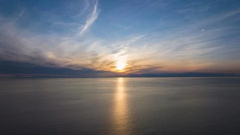 Sunset seascape. The red sun setting among the clouds. blue sky Stock Photos
