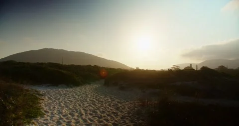 Sunset in the Seaside With Sand Paths and Mountains at the Background Stock Footage 247336766
