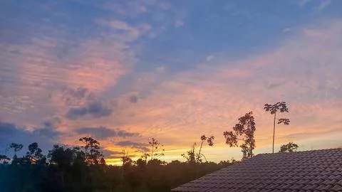 Sunset seen above a rooftop Stock Photos