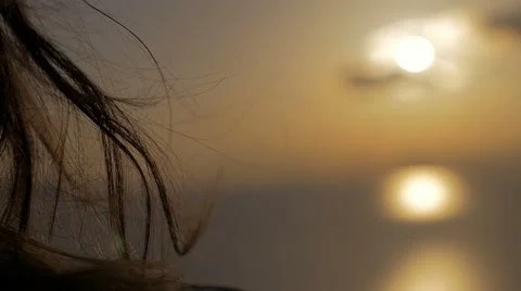 Sunset seen between a woman's hair Stock Footage