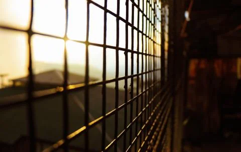 Sunset seen from a Grid Fence inside the House, 5K Stock Photos