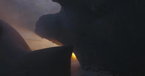 Sunset seen through the rocky cave Stock Footage 103812221