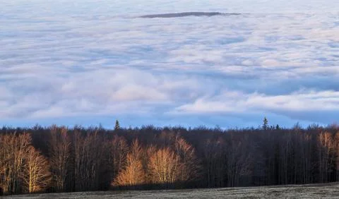 A sunset seen from the top of the mountain with the clouds covering the sur.. Stock Photos