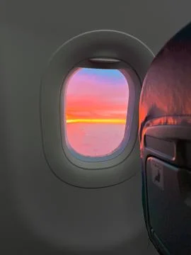 Sunset as seen from the window of a flying airplane. Stock Photos