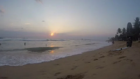 Sunset Serenity on the Beach as Waves Kiss the Shore Stock Footage 317096372