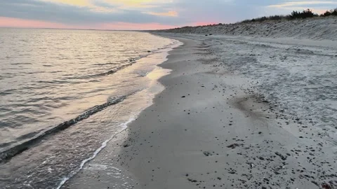 Sunset serenity: gentle waves on the beach of Graal-Mritz, Germany. Stock Footage 319543760