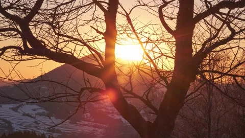 Sunset. The setting sun behind the mountain from behind the silhouettes of a Stock Footage 174158735