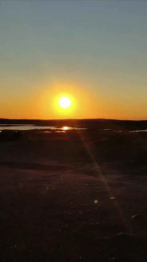 Sunset. Setting sun orange sky rays on horizon in arctic tundra in summer. Video stock 297473080