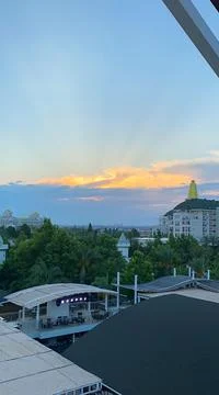 Sunset, the setting sun, the rays of the sun in the clouds. Vacation, tropica Stock Photos