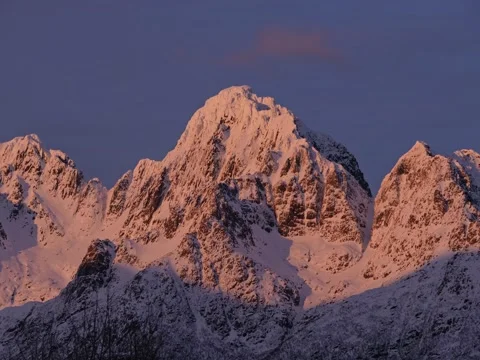 Sunset shadow over snowy mountains in Norway, colors, epic, beautiful, sunset Stock Footage 205963828