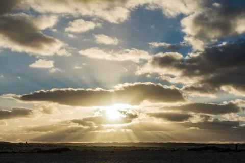 Sunset shining through the clouds on the Spanish island of Fuerteventura Stock Photos