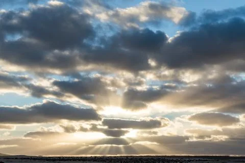 Sunset shining through the clouds on the Spanish island of Fuerteventura Stock Photos