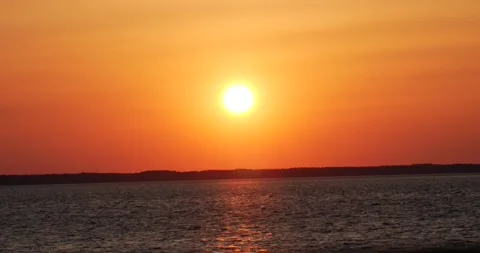 Sunset shinning over bay water slowly moving Stock Footage 150198844