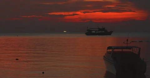 Sunset shot of a boat floating on water Stock Footage 72394372