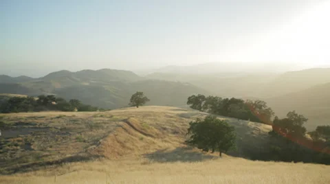 Sunset shots overlooking rolling hills of grass Stockbeeldmateriaal 31742611