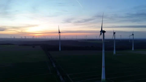 Sunset side pass with turbine cluster in foreground Stock Footage 331214919