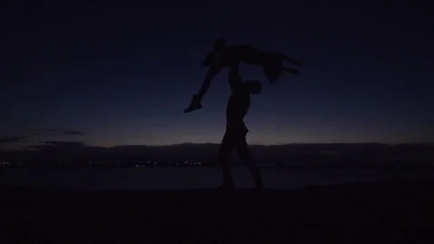 Sunset Silhouette Couple do Partner Acro Lift Slow Motion Stock Footage 79161336