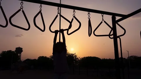 Sunset Silhouette Of Kid Playing On Monkey Bars In Outdoor Recreation Park Stock Footage 340958667