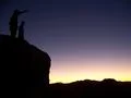 Sunset Silhouette - Men standing on big rock in Joshua Tree National Park Photo