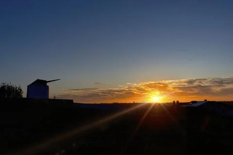 Sunset with the silhouette of a windmill. Foto stock