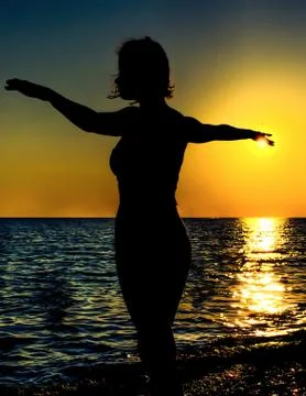 Sunset silhoutte of a beautiful dancer Stock Photos