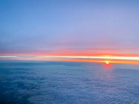 Sunset sky above clouds. Cabin view from airplane.	 Foto stock
