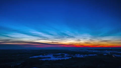 Sunset sky above winter landscapein aerial hyperlapse with car headlights Stock Footage 331302585