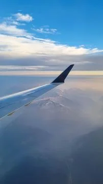 Sunset sky on airplane, plane window, evening flight for relax in holiday Stock Photos
