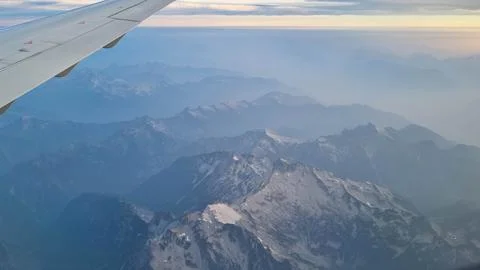 Sunset sky on airplane, plane window, evening flight for relax in holiday Stock Photos
