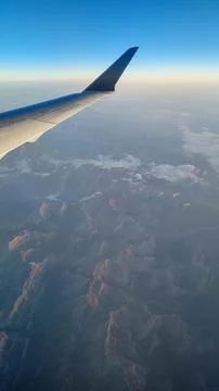 Sunset sky on airplane, plane window, evening flight for relax in holiday Stock Photos