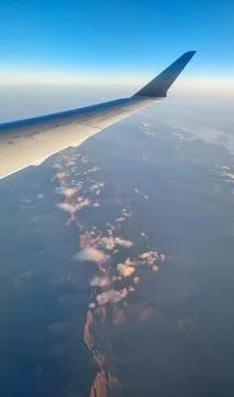 Sunset sky on airplane, plane window, evening flight for relax in holiday Stock Photos