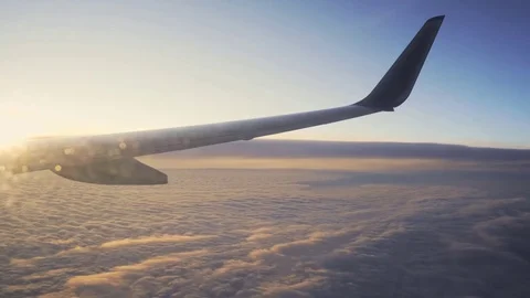 Sunset in the sky from the airplane window wing of the plane. Stock Footage 83521469