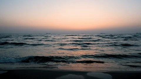 Sunset sky and surf, cargo ships on the horizon, silence 스톡 동영상 110777094
