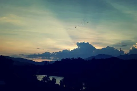 Sunset sky background with clouds and sun, photo image wallpaper Stock Photos