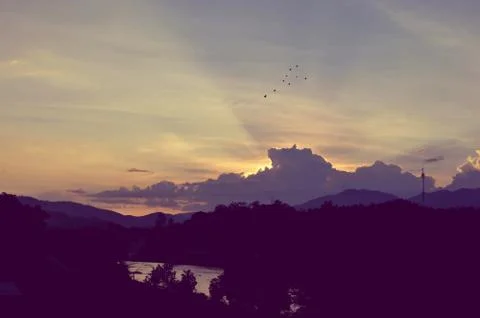 Sunset sky background with clouds and sun, photo image wallpaper Stock Photos