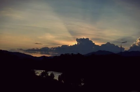 Sunset sky background with clouds and sun, photo image wallpaper Stock Photos