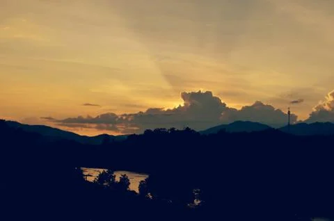 Sunset sky background with clouds and sun, photo image wallpaper Stock Photos