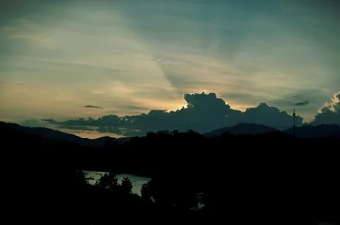 Sunset sky background with clouds and sun, photo image wallpaper Stock Photos