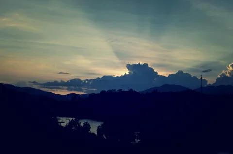 Sunset sky background with clouds and sun, photo image wallpaper Stock Photos