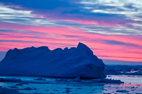 Sunset sky on the background of icebergs in the southern ocean Antarctica Stock Photos
