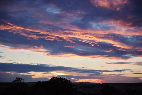 Sunset sky background orange clouds gray stormy clouds Stock Photos