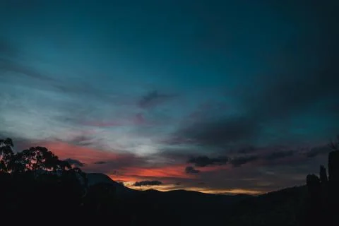 Sunset sky with beautiful pink clouds over the hills of Tasmania Stock Photos