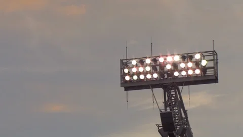 Sunset sky behind the lit stadium lights Stock Footage 102098102