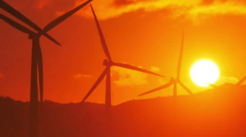 Sunset sky with big sun and spinning rotors of wind mills turbines Stock Footage 51023864