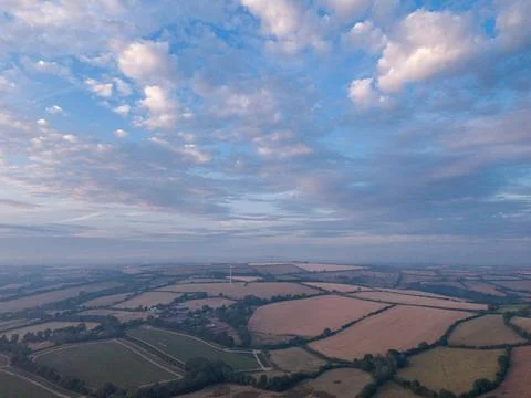 Sunset sky with clouds and mist over rural landscape in Cornwall Stock Photos