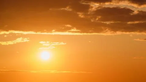 Sunset in the sky with clouds and rays of the setting sun Stock Photos