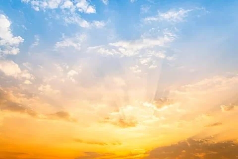 Sunset sky with clouds and rays of sunlight in the evening Stock Photos