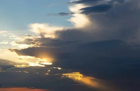 Sunset sky with clouds and rays of sunlight Stock Photos